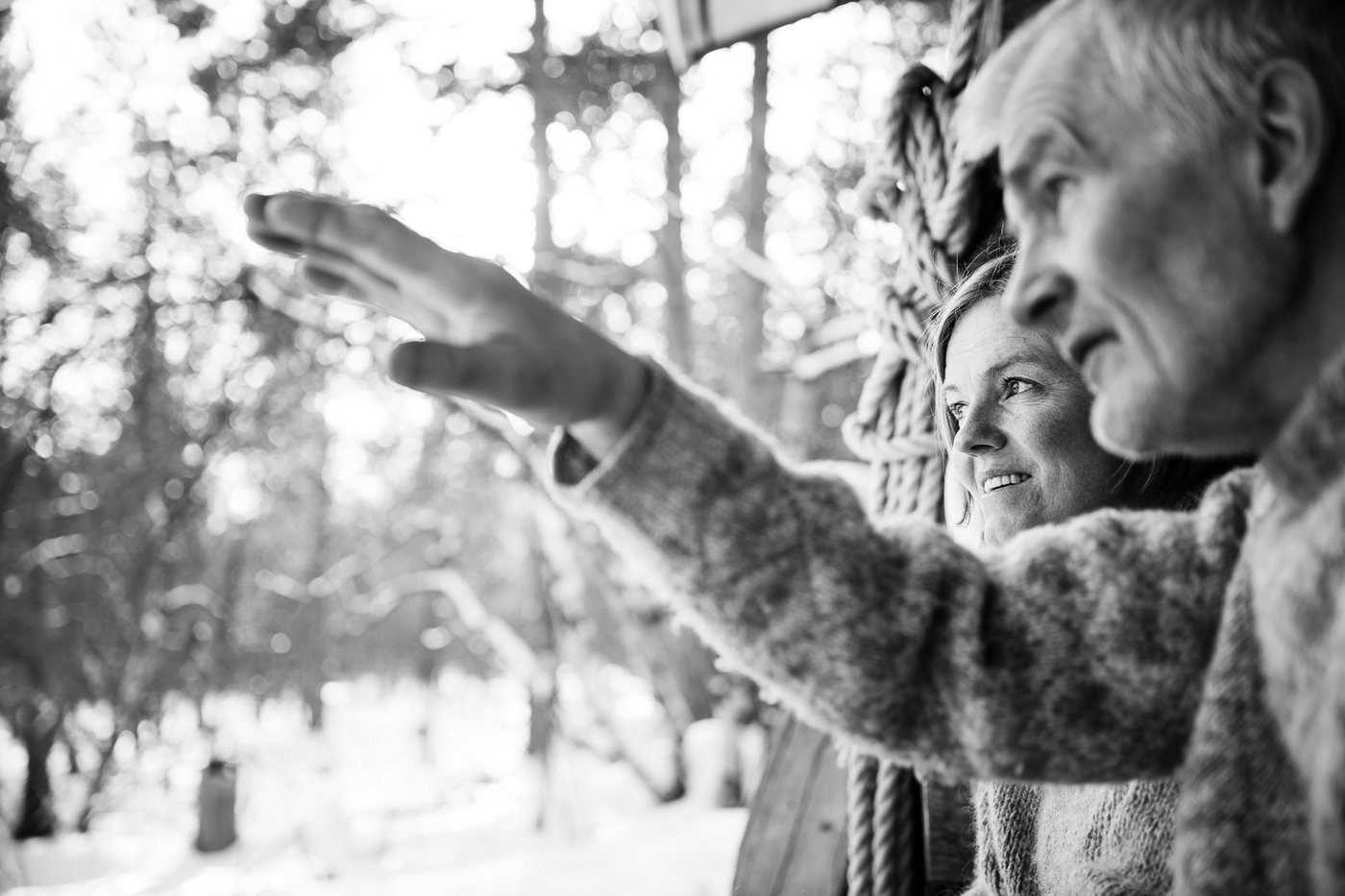 Sven pointing out into the snowy forest, Liv beside him following his hand