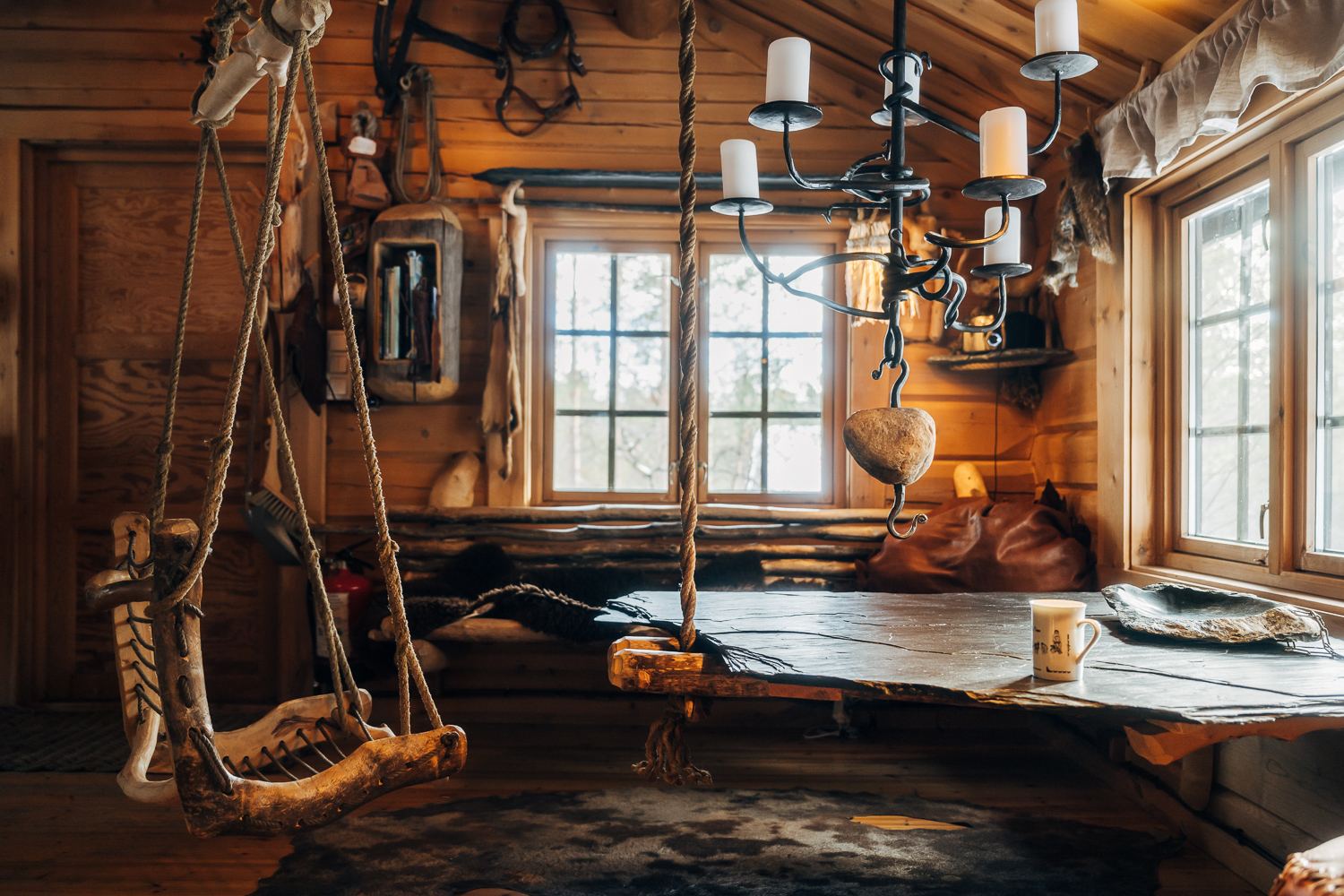 A long table under a candle chandelier by the window
