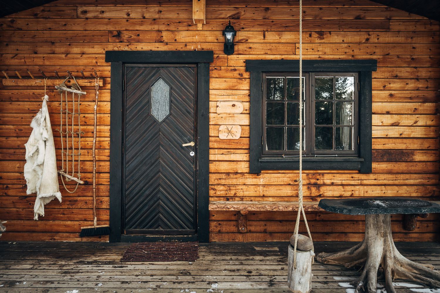 The front door of Danskar with a lantern and a hide beside it