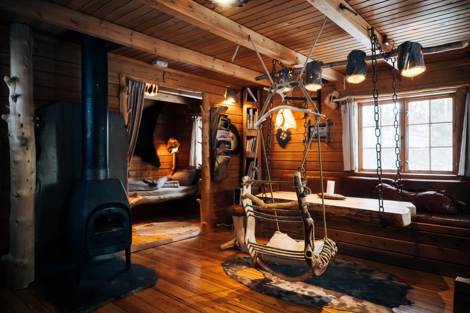Danskar's main room with the stove, a hanging seat and the bed