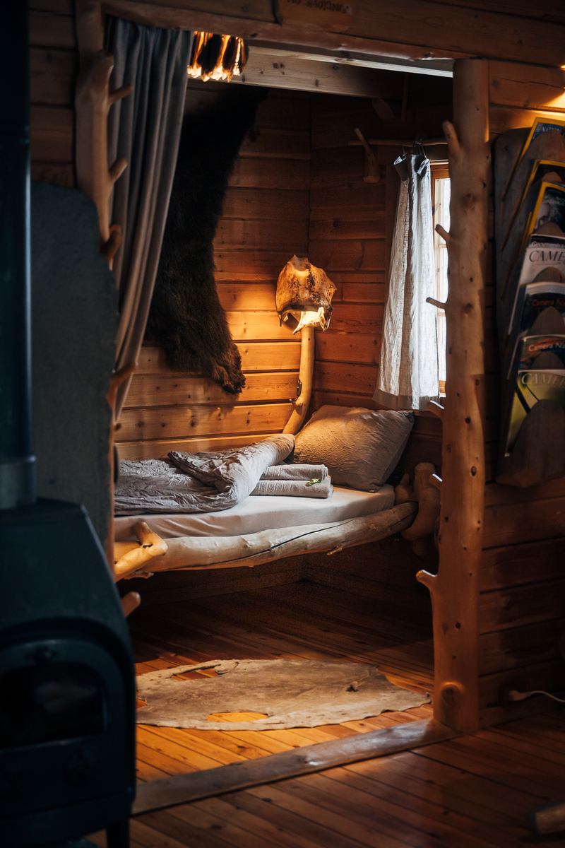 The bed beside the black iron stove