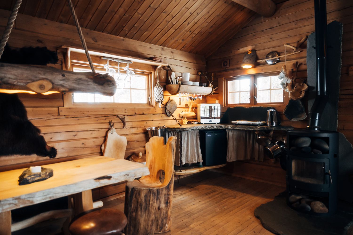 A kitchen bench of whole timber under the window