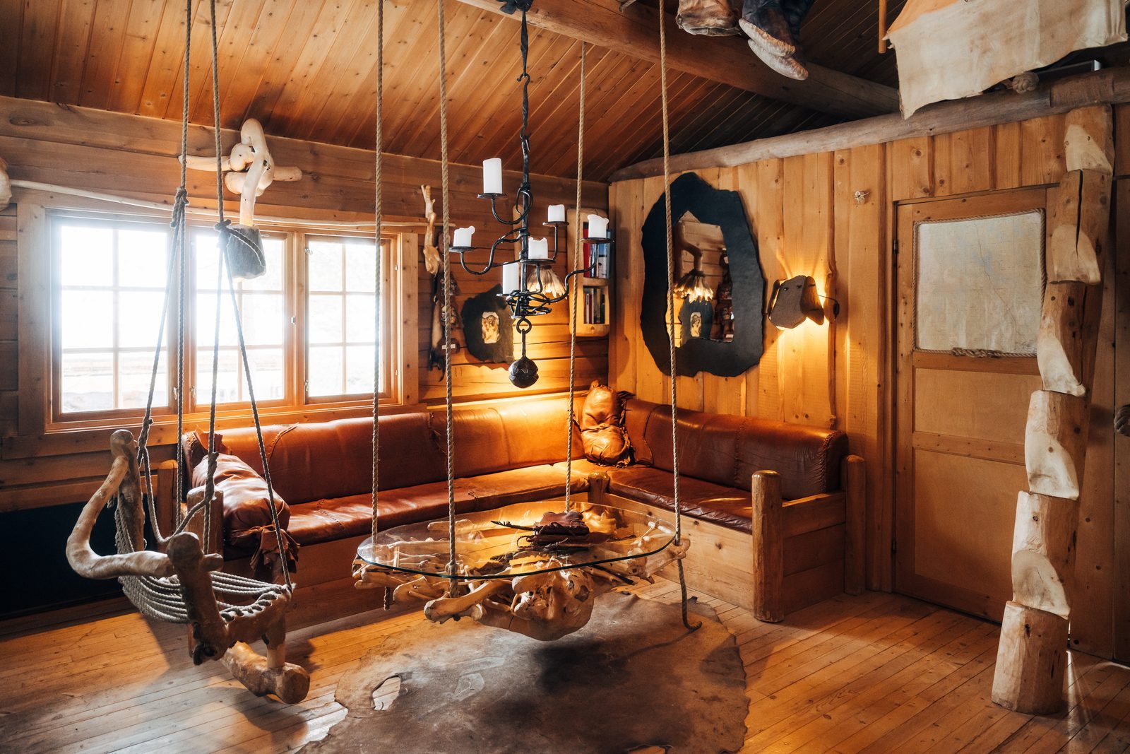 The hearth under a chandelier, with a hanging seat