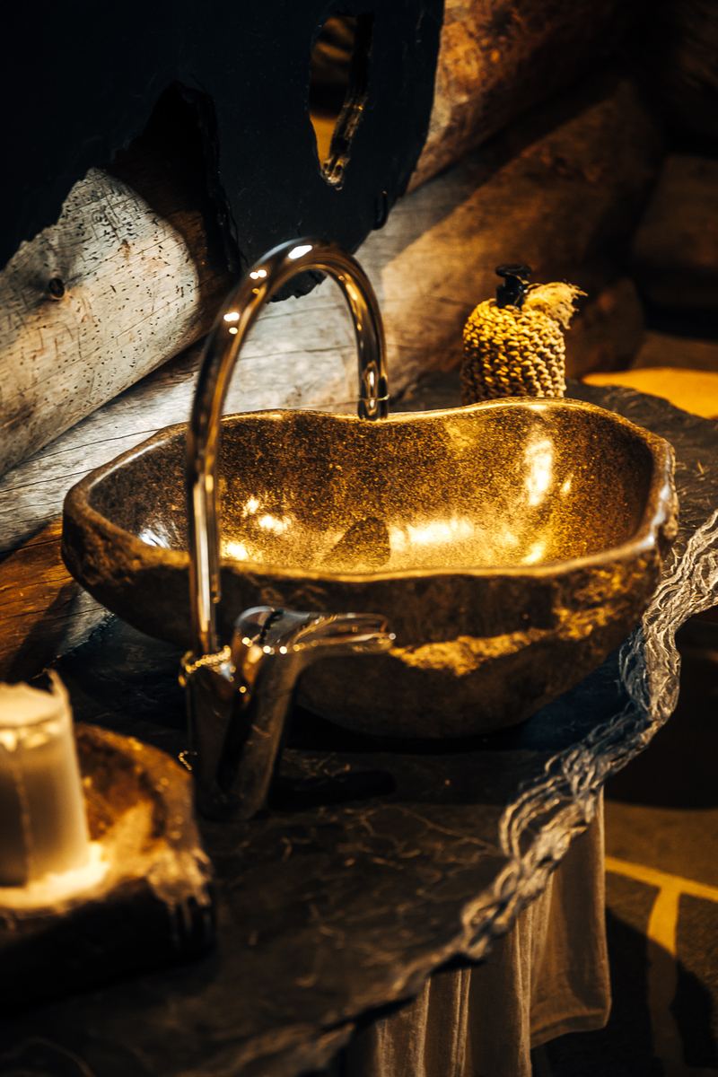 Water running into a basin carved from a single block