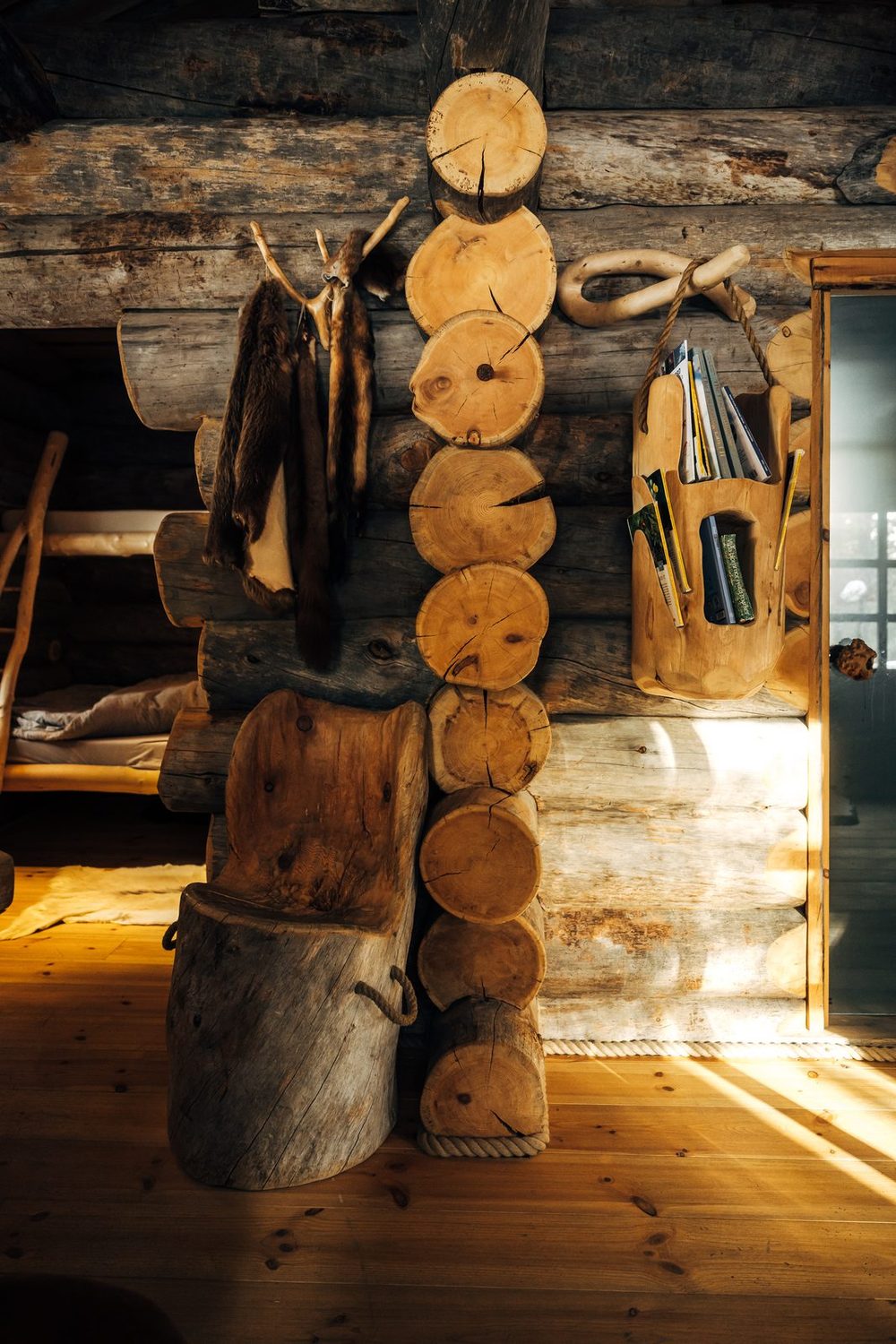 Sawn log ends and kitchen utensils on the wall by the door