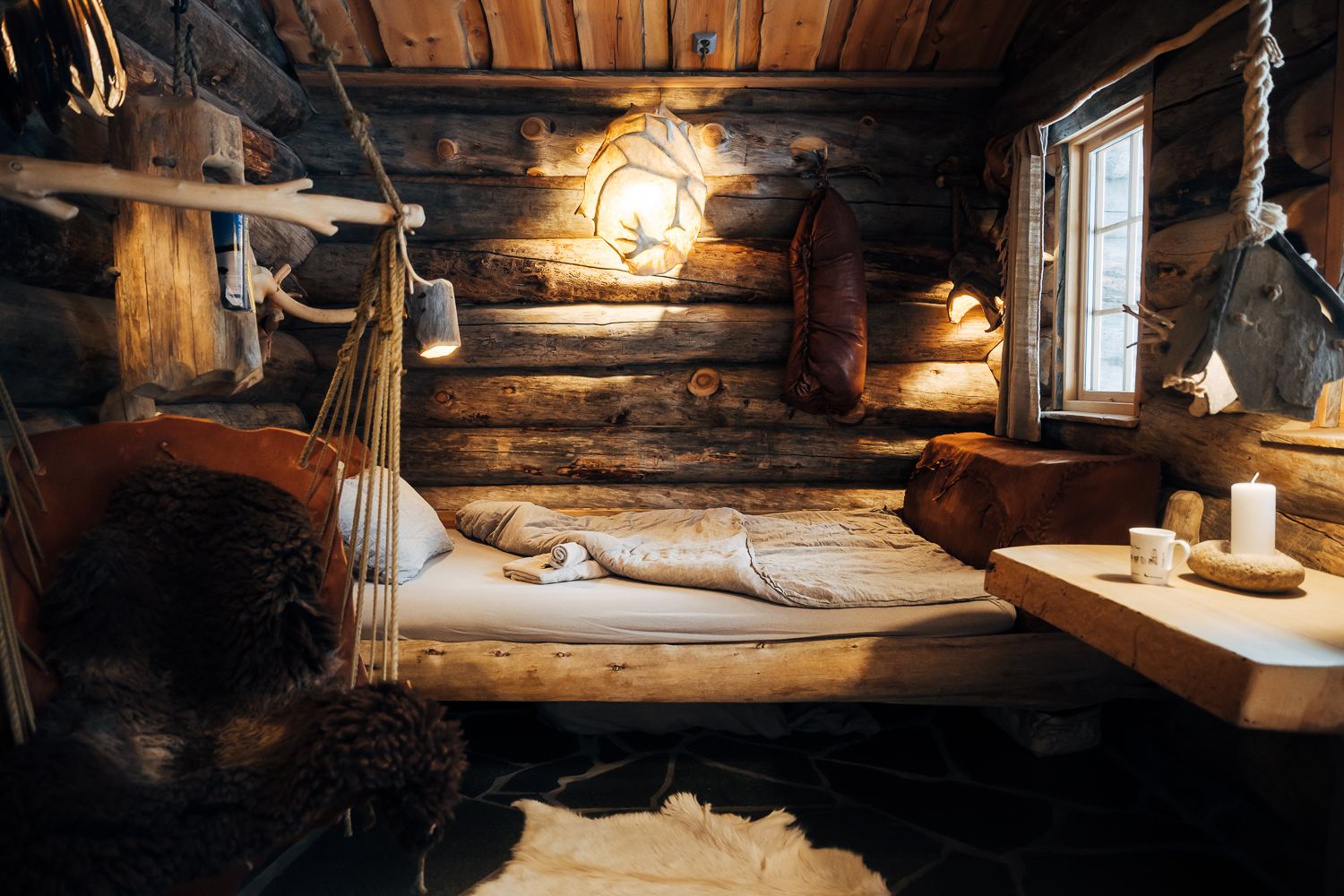 The bed beside the window with candles lit