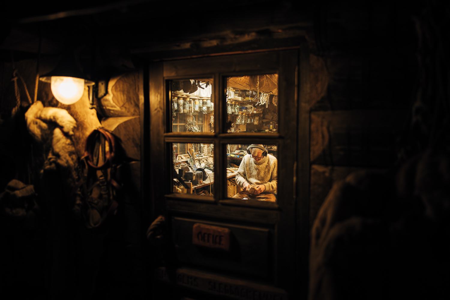 A cabin window glowing warm in the dark