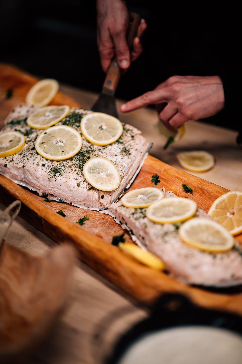 Whole side of fish with lemon on a wooden board