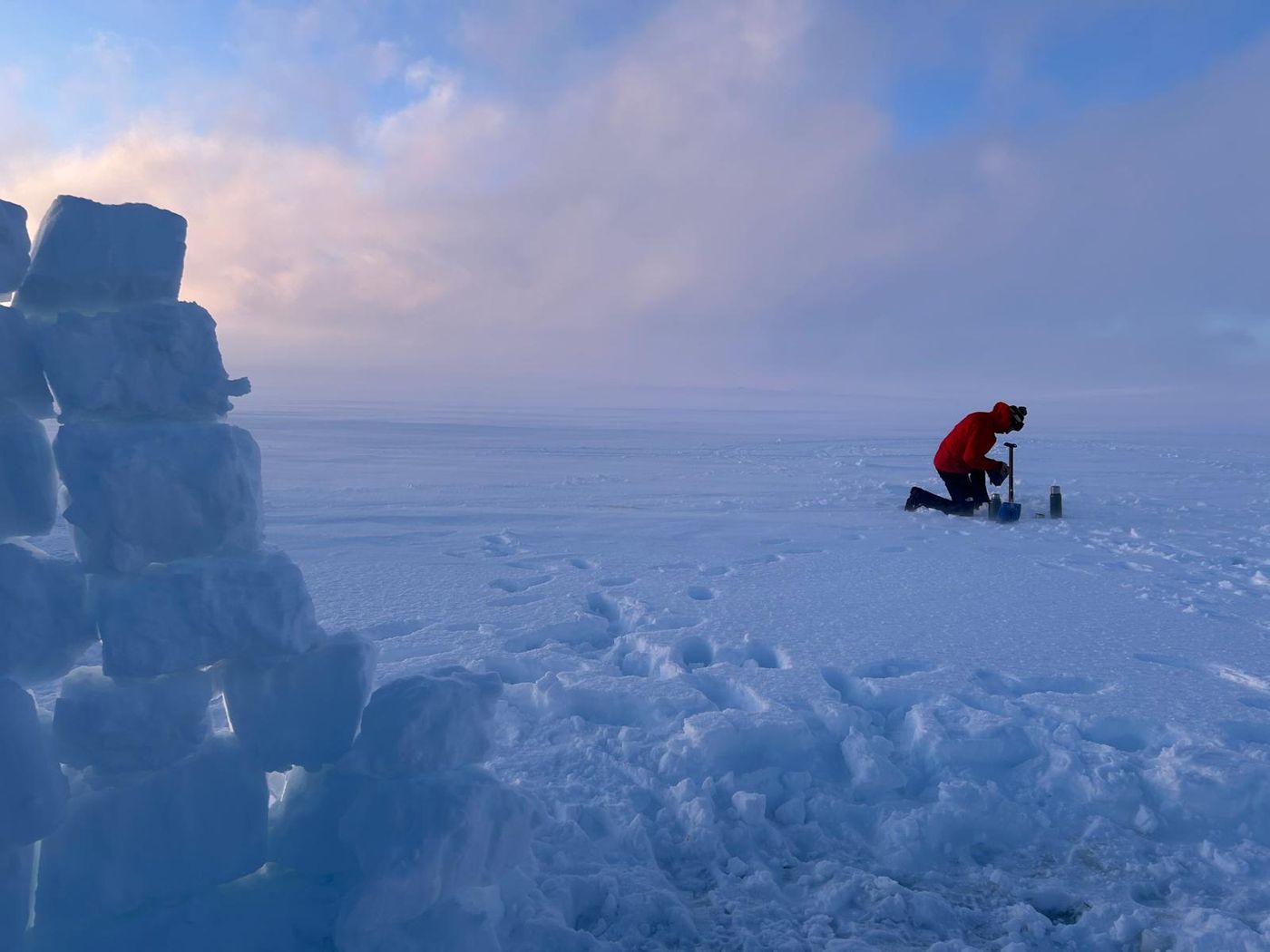 Getting water from drilled ice hole on frozen lake. Turgleder