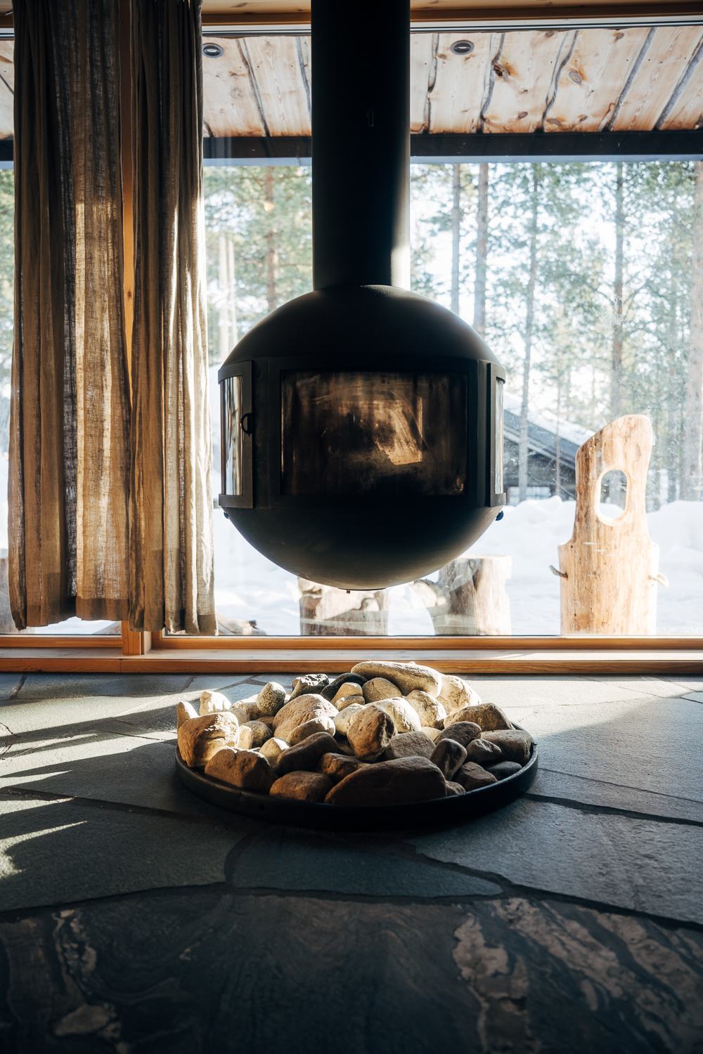 Suspended black iron stove in the cabin